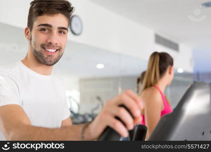 Handsome young man working out at the gym