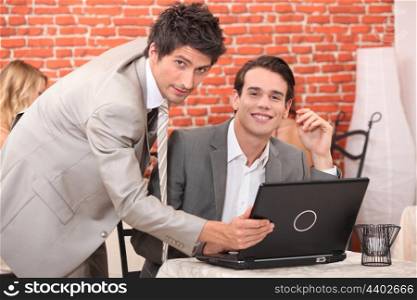 Handsome young men working at a laptop