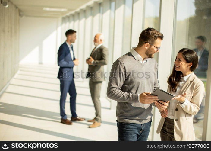 Handsome young modern business people using digital tablet in the office