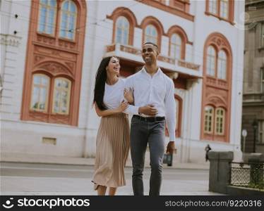 Handsome young multiethnic couple walking on the street
