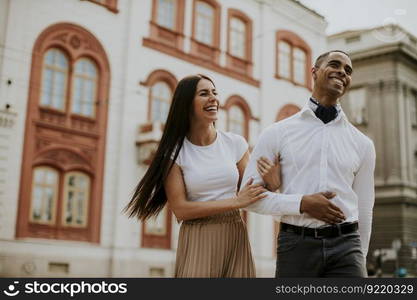 Handsome young multiethnic couple walking on the street