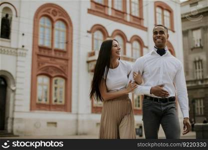 Handsome young multiethnic couple walking on the street