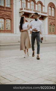 Handsome young multiethnic couple walking on the street