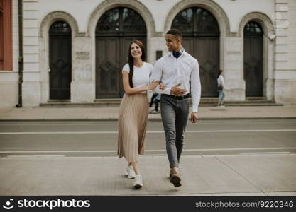 Handsome young multiethnic couple walking on the street