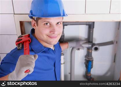 Handsome young plumber with a wrench