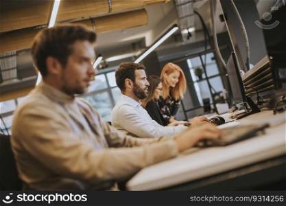 Handsome young professional businessman uses a computer for work in the modern office