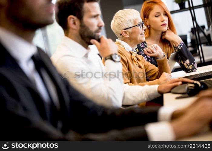 Handsome young professional businessman uses a computer for work in the modern office