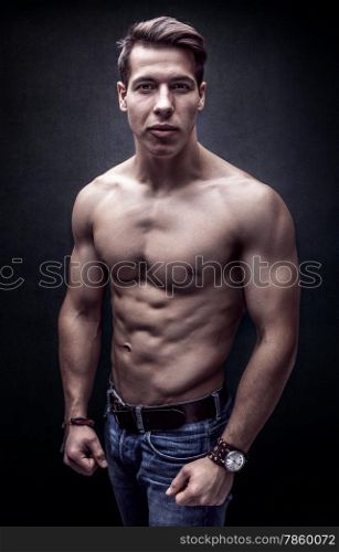 Handsome young strong man posing bare chest