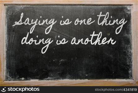 handwriting blackboard writings - Saying is one thing, doing is another
