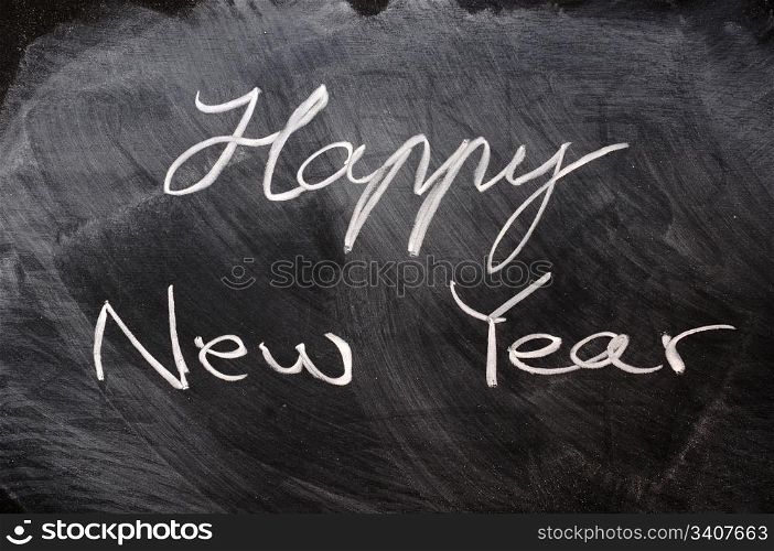 Handwriting of Happy New Year on a blackboard