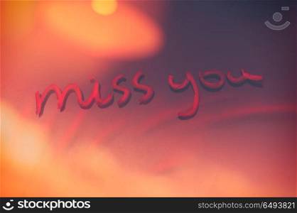 Handwritten phrase miss you on the window glass, abstract background, love and happiness on Valentines day holiday. Miss you background