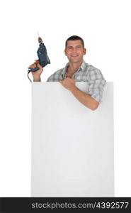 Handyman behind white board