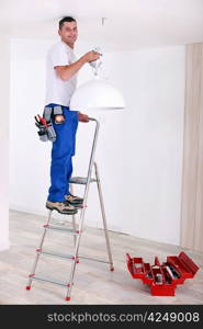 Handyman fixing lighting