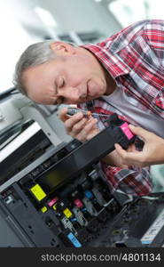 handyman fixing the office printer