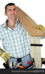 Handyman holding plank