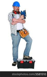 Handyman holding power sander