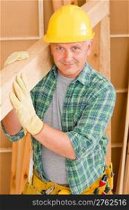 Handyman home improvement carpenter mature professional carry wooden beam