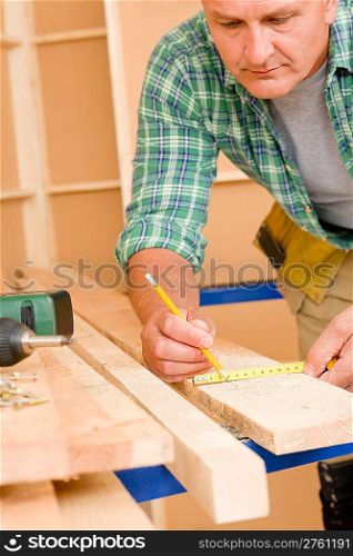 Handyman home improvement close-up of measure wooden board with ruler