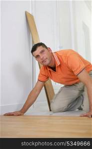 Handyman laying laminate floor