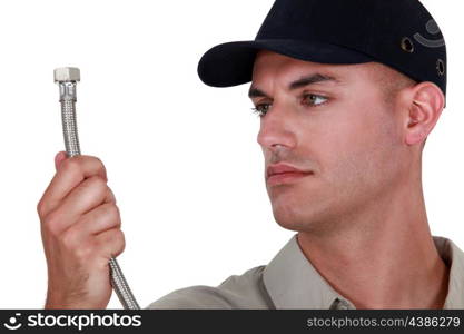 Handyman looking at a pipe.