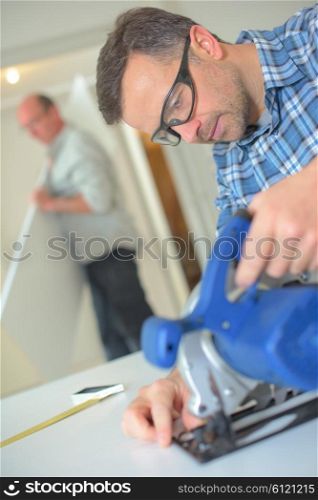 Handyman using a band saw