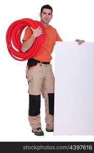 Handyman with cabling around his shoulder