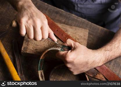 handyman working leather belt