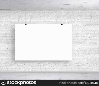 Hanging banner. Blank white banner hanging on wall. Place for text
