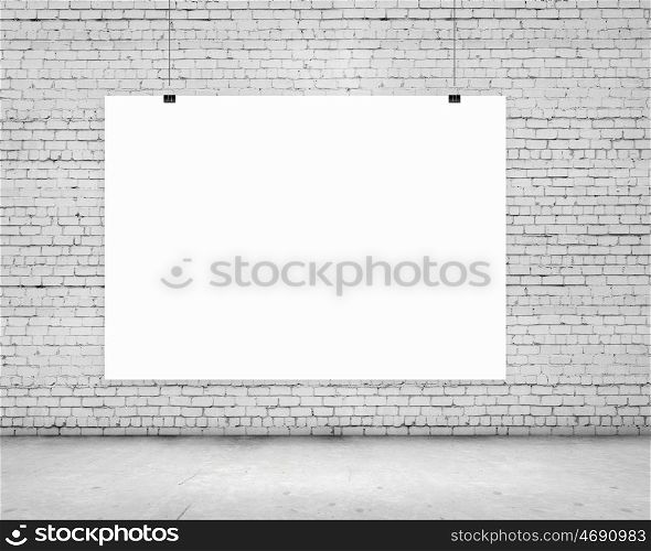 Hanging banner. Blank white banner hanging on wall. Place for text
