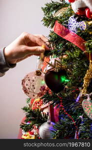 Hanging Christmas decorations and ornaments in the Christmas tree