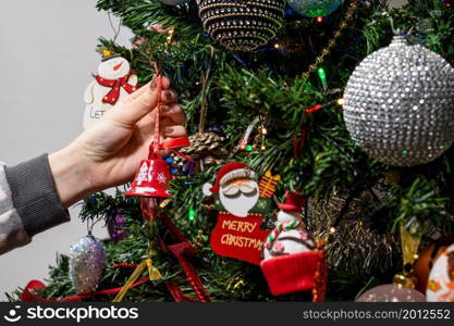 Hanging Christmas decorations and ornaments in the Christmas tree