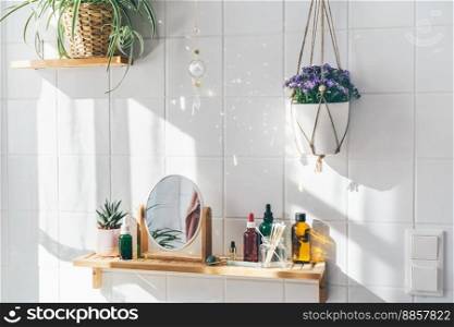Hanging crystal sun catcher against white tile wall in modern eco friendly bathroom. Shadows on the wall. Hanging crystal sun catcher against white tile wall