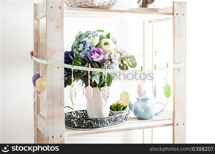 Hanging eggs on the ribbon - Easter decortaions on the shelf indoor. Easter decortaions interior