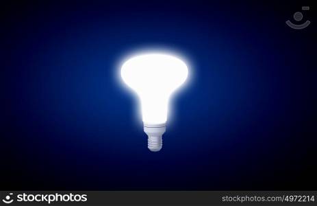 Hanging light bulb. Glowing inverted light bulb on dark background