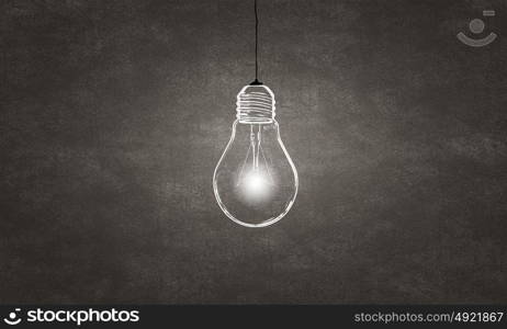 Hanging light bulb. Glowing light bulb on dark background hanging from above