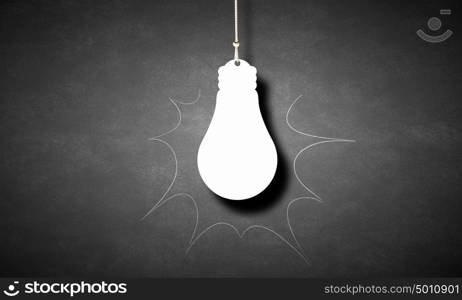 Hanging light bulb. Illuminating hanging light bulb on dark background