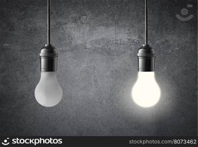 Hanging light bulbs on grunge wall. Idea concept