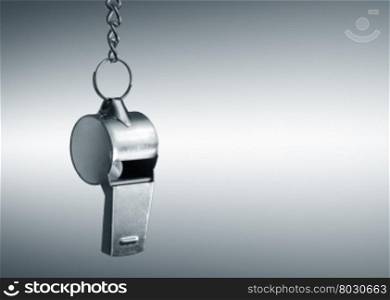 Hanging metal whistle closeup photo