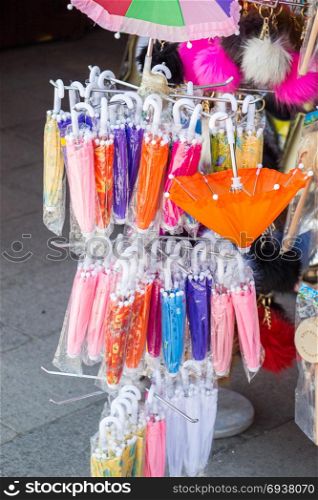 Hanging models umbrellas of various color in the market place