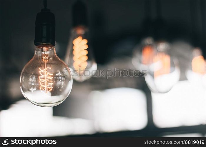 Hanging old vintage light bulb (selective focus)