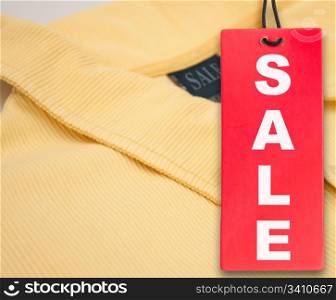 Hanging Red Sale Tag and Yellow Polo Shirt