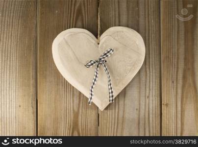 hanging valentines heart shape on wooden backkground