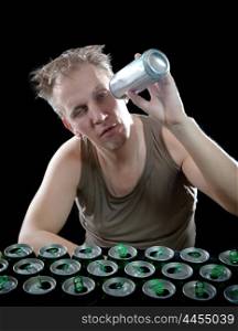 Hangover. The man examines, whether there is no beer drop in a can