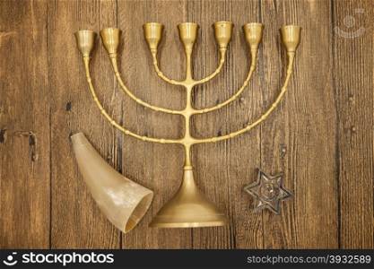 Hanukkah is the Jewish New Year. Candle with Christmas ornaments and cookies horn on wooden background. Hanukkah is the Jewish New Year. Candle with Christmas ornaments and cookies horn on wooden background.