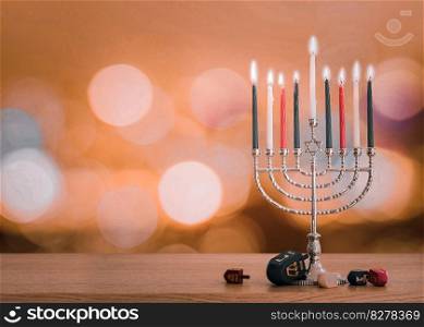 Hanukkah Jewish holiday background with menorah  Judaism candelabra   burning candles and traditional Dreidrel game toy on wood table and on autumn bokeh sun flare
