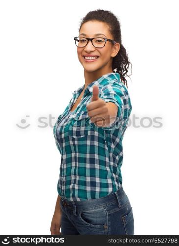 hapiness and people concept - smiling young african american woman in eyeglasses showing thumbs up