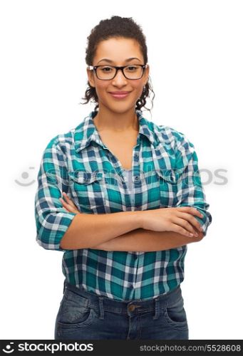 hapiness and people concept - smiling young african american woman in eyeglasses with crossed arms