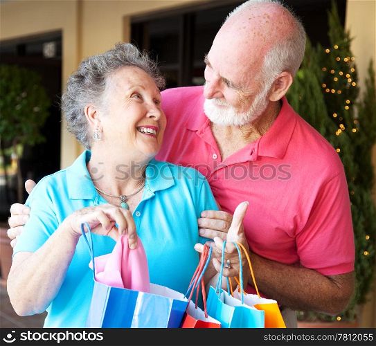 Happily married senior couple on a shopping strip together.