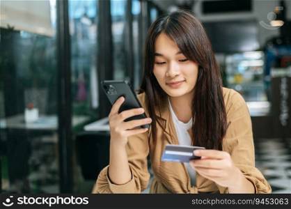 Happily Young woman use credit card to payment on shopping online, smart payment, contactless payment concept