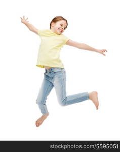 happiness, activity and child concept - smiling little girl jumping